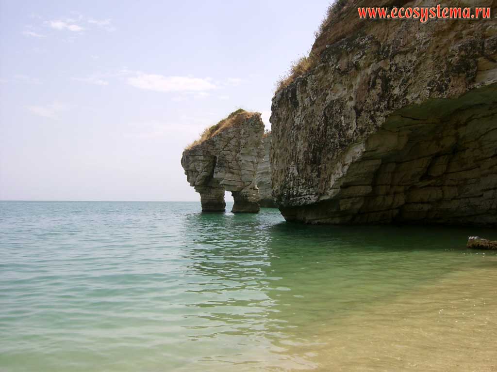 Limestone arches-buttes - the result of abrasion, ie karst weathering of rocks in the Gulf of Manfredonia (Golfo di Manfredonia) in the Adriatic Sea. Near the town of Baia delle Zagare, Gargano National Park, province of Foggia, Apulia (Puglia) Region, Southern Italy