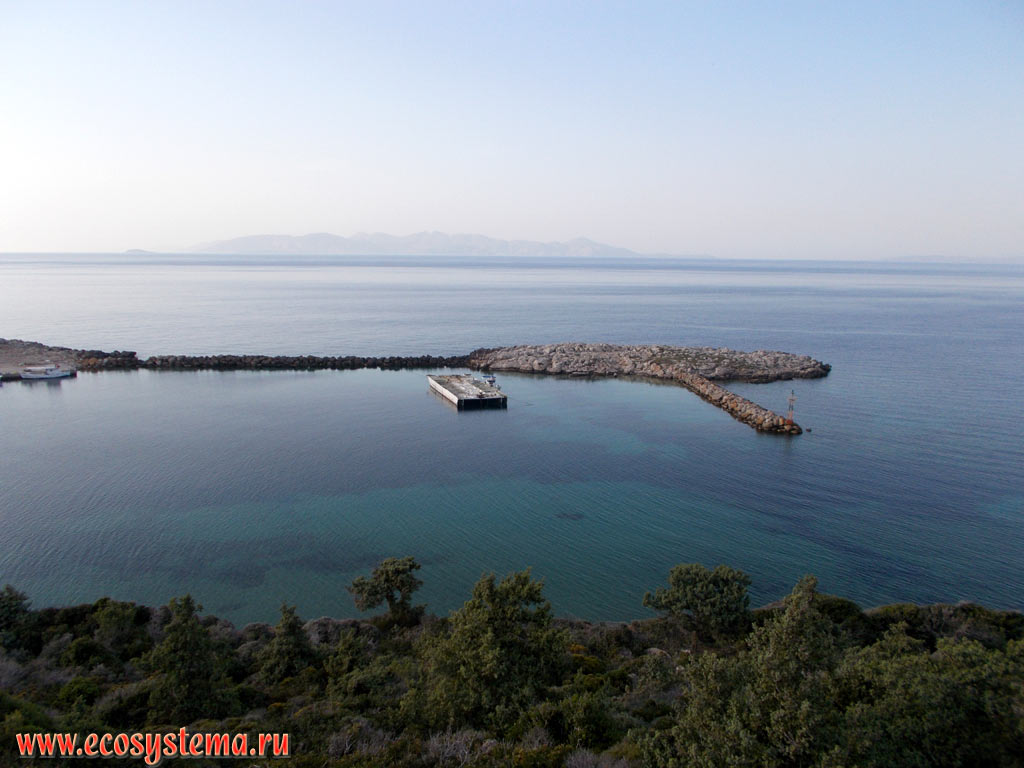 Bay with a landing stage in the North of the Kefalos Peninsula on the South-West coast of the island of Kos, the Aegean Sea and the island of Kalymnos in the distance